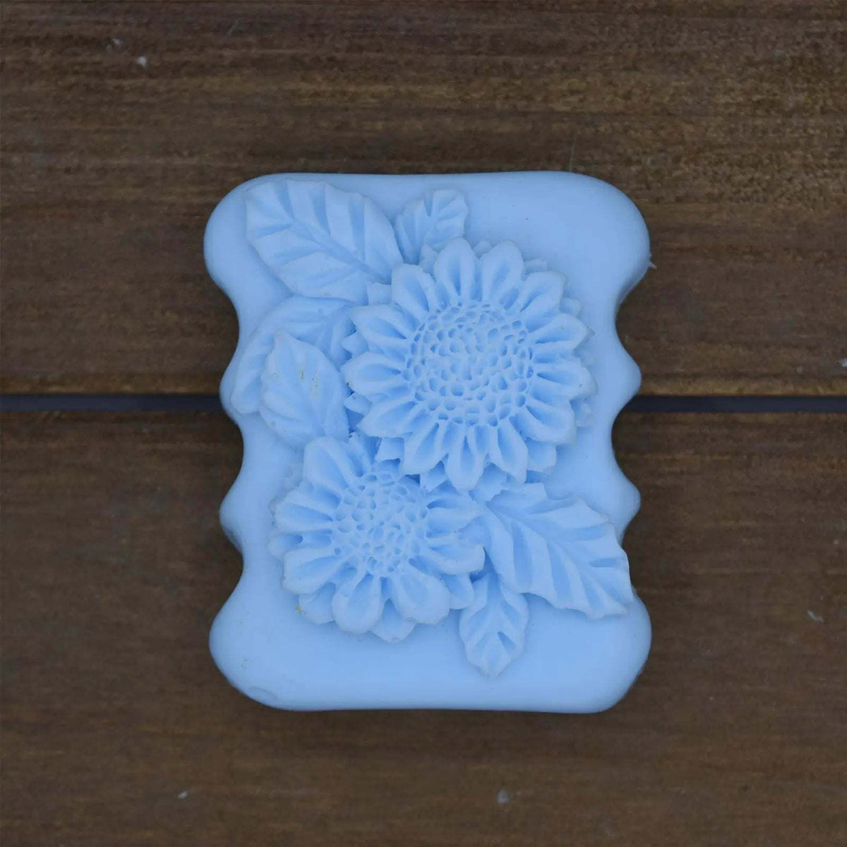 Decorative Natural Crafted soap in light blue with intricate floral and leaf patterns embossed on a rectangular bar.
