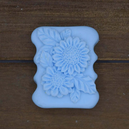Decorative Natural Crafted soap in light blue with intricate floral and leaf patterns embossed on a rectangular bar.