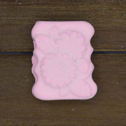 Decorative Natural Crafted soap bar in soft pink with floral embossed pattern and wavy edges, handcrafted and elegant.