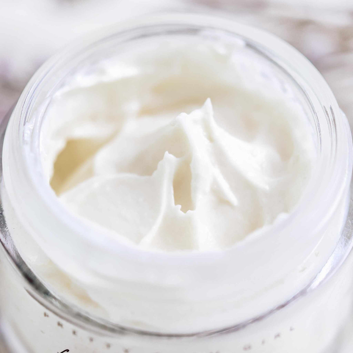 Fresh face cream by Pretty Farm Girl with a smooth, creamy texture in a jar, designed for anti-aging and moisturizing skin.