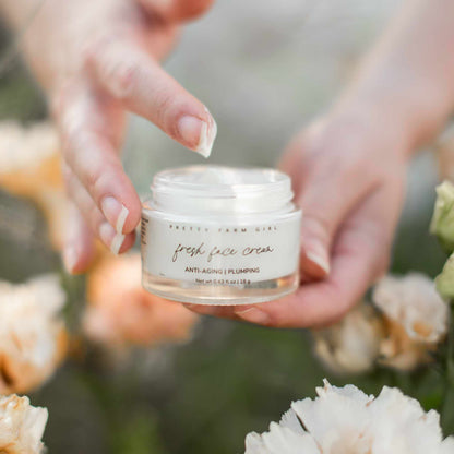 Fresh face cream by Pretty Farm Girl, anti-aging tallow moisturizer in a jar, showing smooth, creamy texture and natural ingredients.