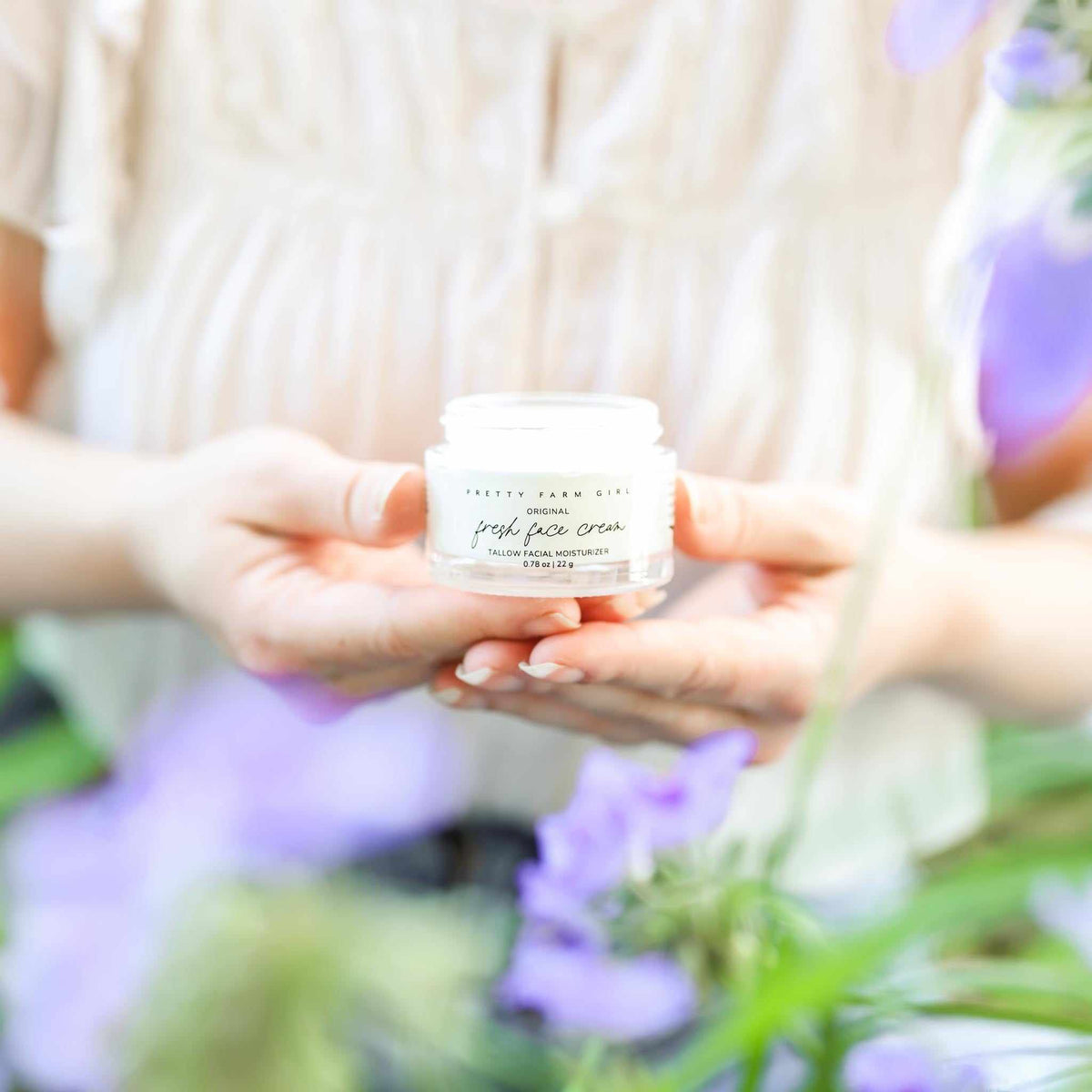 Fresh Face Cream by Pretty Farm Girl, an anti-aging tallow moisturizer in a jar with a natural, creamy texture.
