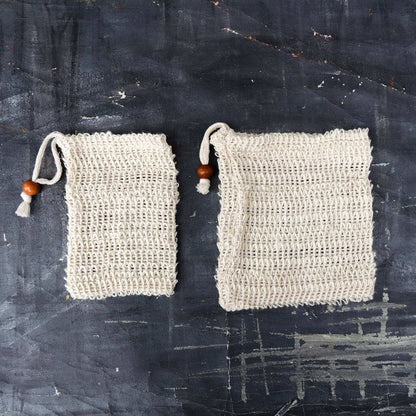 Soap Bag set in natural beige sisal fiber with open weave texture and drawstring closure featuring a wooden bead detail.