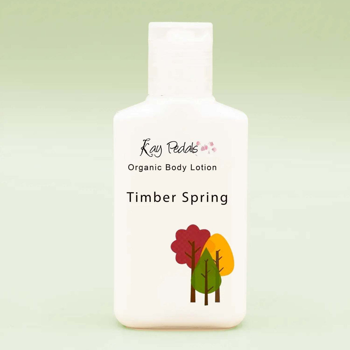 Small white plastic bottle of Kay Pedals Scent Discovery Trio organic body lotion in Timber Spring scent with tree graphic on front