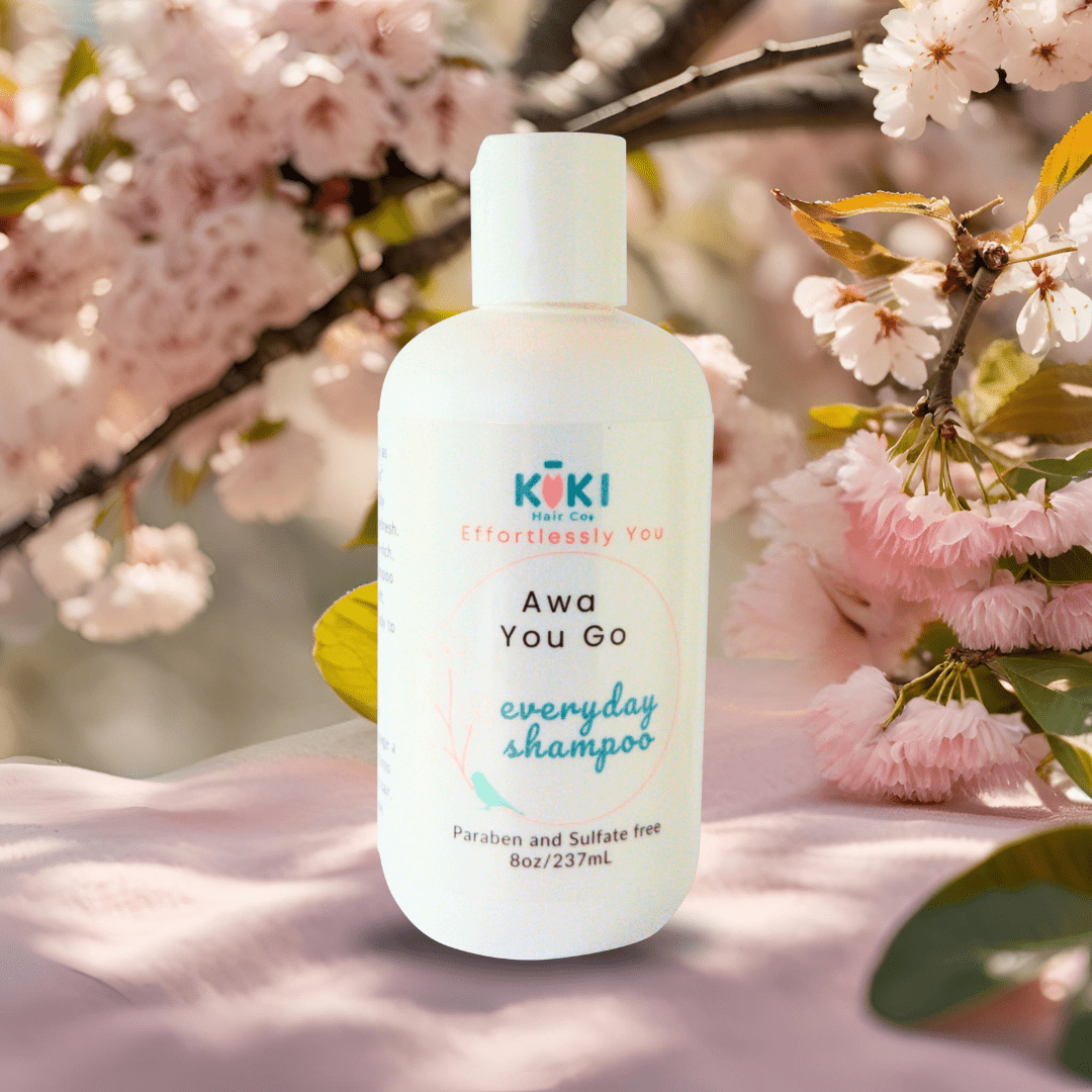 Everyday Lightweight Shampoo in a white plastic bottle with teal and black text, featuring a minimalist design and soft pink floral accents.