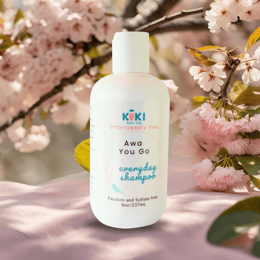Everyday Lightweight Shampoo in a white plastic bottle with teal and black text, featuring a minimalist design and soft pink floral accents.