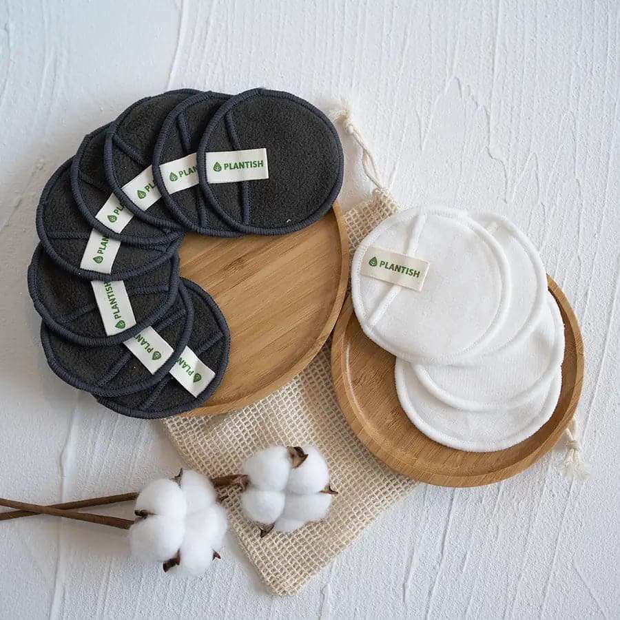 Reusable Cotton Rounds in black bamboo charcoal and white cotton, circular with Plantish logo labels, eco-friendly and soft.