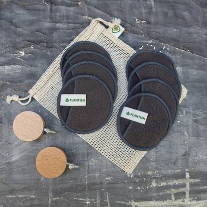 Bamboo Charcoal Facial Rounds Set featuring dark gray reusable cotton rounds with Plantish label, organic mesh bag, and wooden wall hooks.