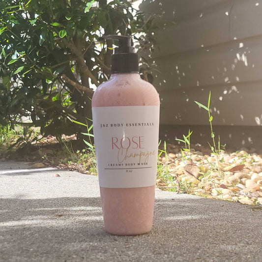 Creamy Rose Champagne body wash in an 8oz bottle from JAZ Body Essentials, featuring a soft pink liquid and elegant label.