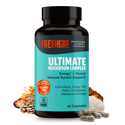 Organic Mushroom Complex supplement capsules by FreshCap Mushrooms, showing 60 capsule bottles in a natural setting.